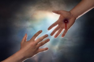 Hand of Christ reaching down from heaven to grab the hand of man